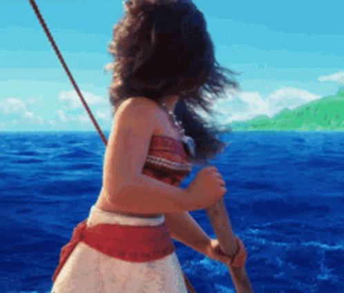 A Woman In A Red And White Dress Is Holding A Paddle In The Ocean . GIF