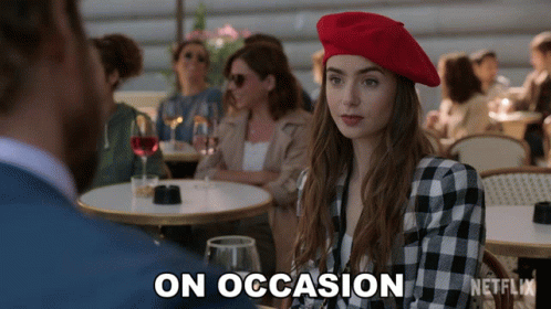 A Woman In A Red Beret Sits At A Table With A Netflix Logo On The Bottom GIF