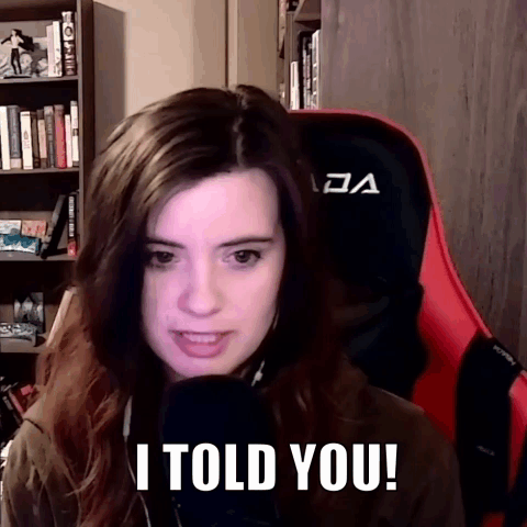 a woman in a red chair says i told you in front of a microphone