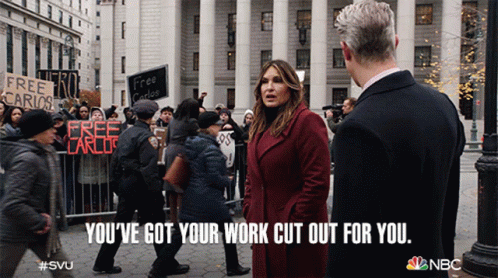 A Woman In A Red Coat Stands Next To A Man In A Black Suit And Says You 'Ve Got Your Work Cut Out GIF