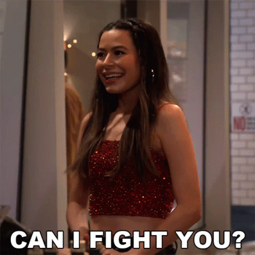A Woman In A Red Crop Top Is Smiling And Asking " Can I Fight You " GIF