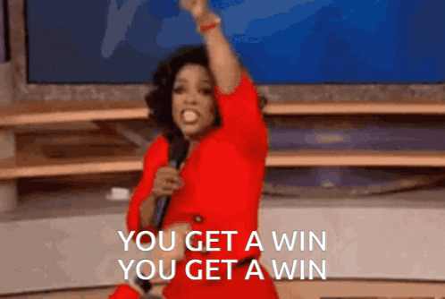 A Woman In A Red Dress Holds A Microphone And Says You Get A Win You Get A Win GIF