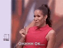 A Woman In A Red Dress Is Crying On A Stage And Saying `` Ohhhh Ok ... '' . GIF