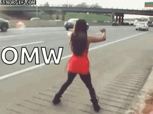 A Woman In A Red Dress Is Dancing On The Side Of A Highway With The Word Omw In White Letters GIF