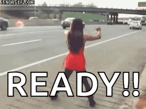 A Woman In A Red Dress Is Dancing On The Side Of A Highway With The Word Ready . GIF