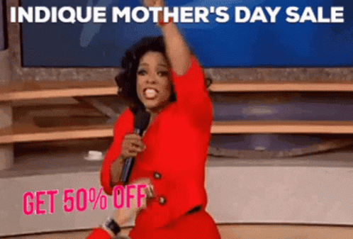 a woman in a red dress is holding a microphone in front of a sign that says indice mother 's day