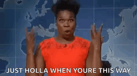 A Woman In A Red Dress Is Making A Devil Horns Gesture . GIF