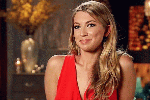 A Woman In A Red Dress Is Making A Face GIF