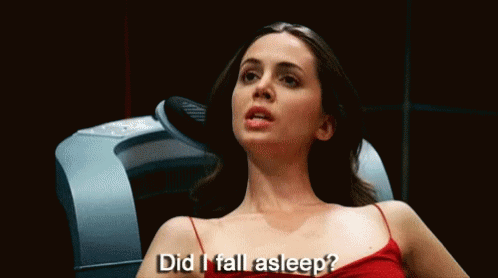 A Woman In A Red Dress Is Sitting In A Chair And Says Did I Fall Asleep . GIF