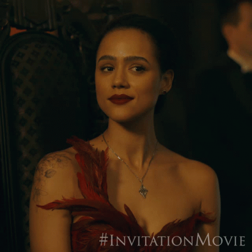 A Woman In A Red Dress Is Sitting In A Chair With The # Invitationmovie Written On The Bottom GIF