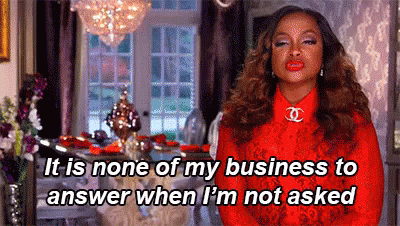 A Woman In A Red Dress Is Standing In A Living Room And Talking About Her Business . GIF