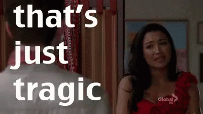A Woman In A Red Dress Is Standing Next To A Man In A White Shirt And Looking At Him . GIF