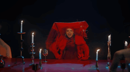 A Woman In A Red Dress Is Surrounded By Lit Candles And Says I Warned You GIF