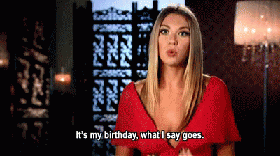 A Woman In A Red Dress Is Talking About Her Birthday . GIF