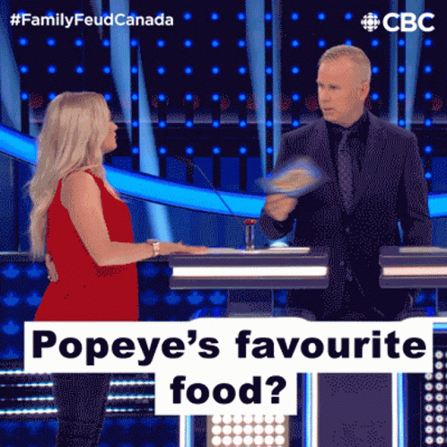 A Woman In A Red Dress Is Talking To A Man In A Suit On A Television Show Called Family Feud Canada GIF