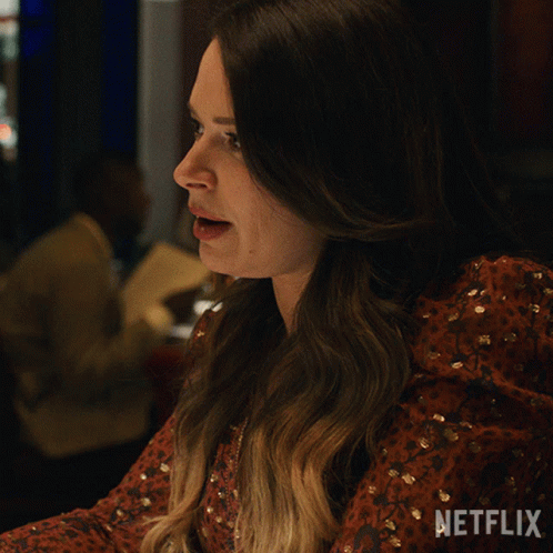 A Woman In A Red Dress Says Dramatic Much On A Netflix Ad GIF