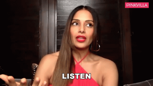 A Woman In A Red Dress Says Listen With Her Hands Out GIF