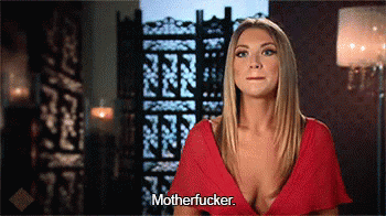 A Woman In A Red Dress Says Motherfucker In Front Of A Screen GIF