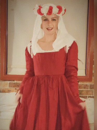 A Woman In A Red Dress With A White Veil Is Smiling GIF
