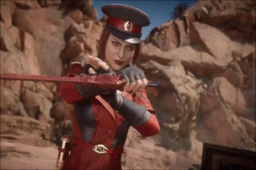 A Woman In A Red Hat Is Holding A Bloody Sword In Her Hands . GIF