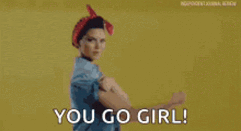 A Woman In A Red Headband Is Flexing Her Muscles And Says `` You Go Girl '' . GIF