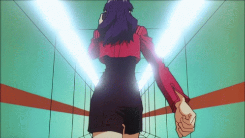 A Woman In A Red Jacket And Black Shorts Stands In A Hallway GIF