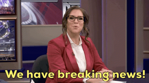 A Woman In A Red Jacket And Glasses Says " We Have Breaking News " GIF