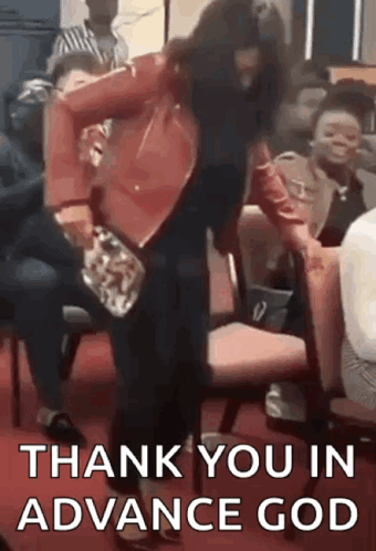 A Woman In A Red Jacket Is Dancing In Front Of A Crowd Of People While Sitting In Chairs . GIF