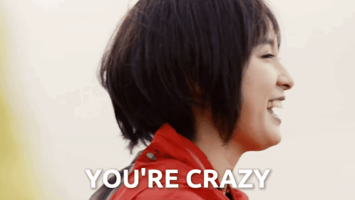 A Woman In A Red Jacket Is Laughing With The Words You 'Re Crazy Above Her GIF