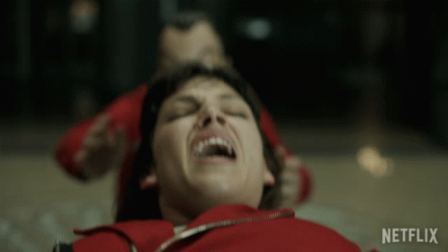 A Woman In A Red Jacket Is Laying On The Floor With A Netflix Logo In The Corner GIF