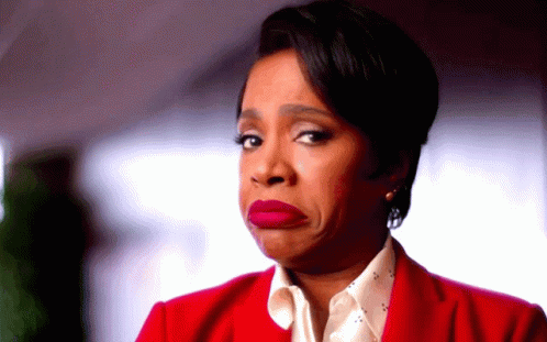 A Woman In A Red Jacket Is Making A Face GIF