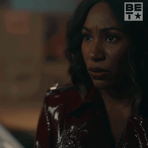 A Woman In A Red Jacket Is Saying Wait . GIF