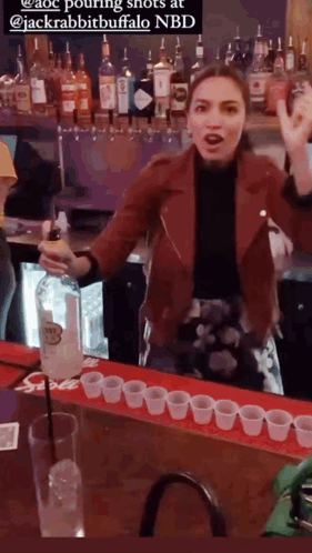 A Woman In A Red Jacket Pouring Shots At Jackrabbit Buffalo GIF