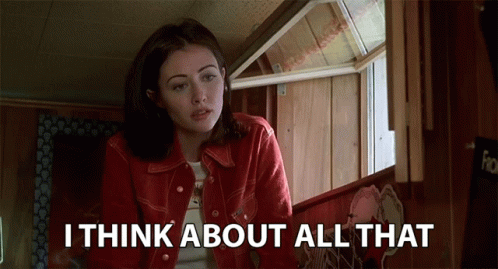 A Woman In A Red Jacket Says " I Think About All That " In Front Of A Window GIF