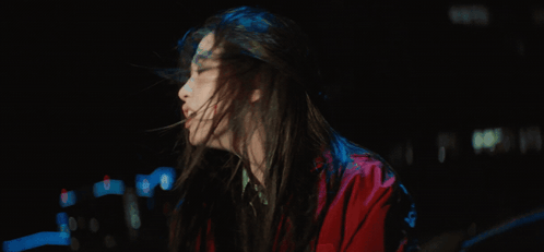 A Woman In A Red Jacket With Her Mouth Open GIF