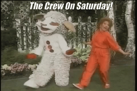 A Woman In A Red Jumpsuit Is Dancing Next To A Snowman In A White Outfit . GIF