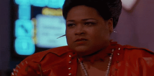A Woman In A Red Leather Jacket Has A Needle In Her Neck GIF