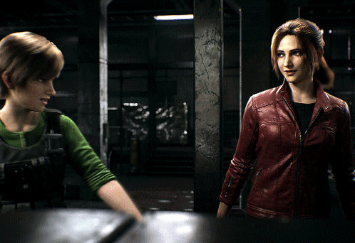 A Woman In A Red Leather Jacket Talks To Another Woman In A Green Shirt GIF