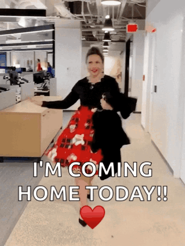 A Woman In A Red Plaid Dress Is Walking Down A Hallway With The Words " I 'M Coming Home Today " GIF