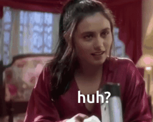 A Woman In A Red Robe Is Sitting At A Table With A Napkin In Her Hand . GIF