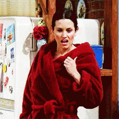 Woman In Red Robe Standing In Front Of Fridge GIF
