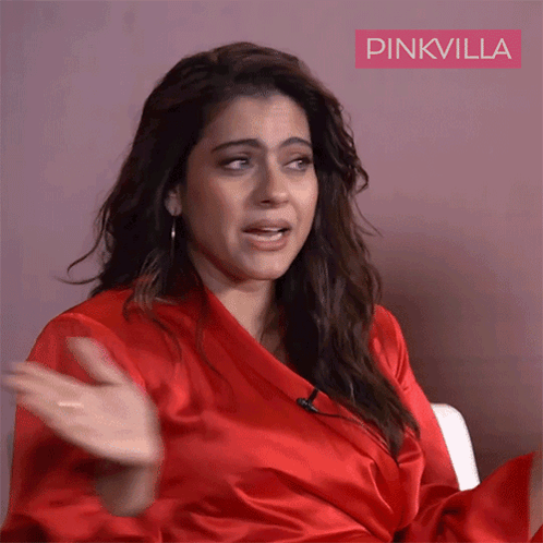 A Woman In A Red Robe With Pinkvilla Written On The Bottom Right GIF
