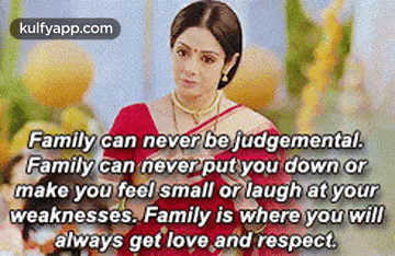 A Woman In A Red Sari Is Sitting At A Table With A Quote That Says Family Can Never Be Judgemental . GIF