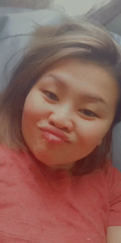 A Woman In A Red Shirt Is Making A Face GIF