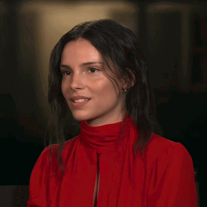 A Woman In A Red Shirt Is Pointing Her Finger GIF