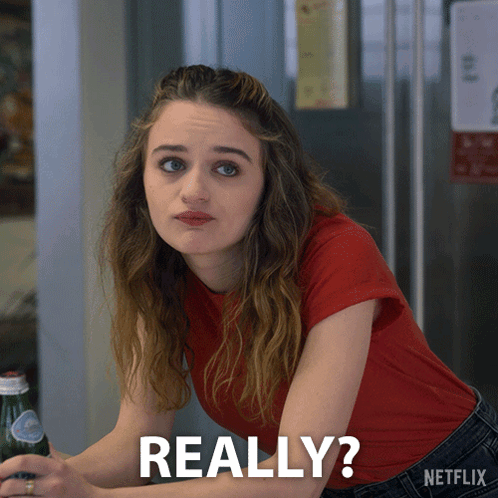 A Woman In A Red Shirt Is Sitting At A Table With A Bottle Of Soda And The Words Really Written On The Bottom GIF