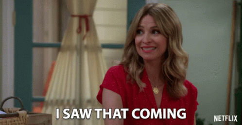 A Woman In A Red Shirt Is Smiling And Says I Saw That Coming GIF