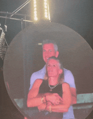 A Woman In A Red Shirt Is Standing In Front Of A Large Circle GIF