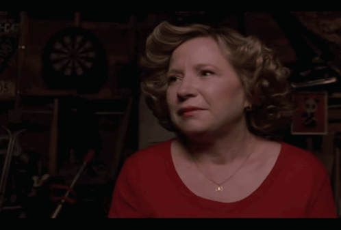 A Woman In A Red Shirt Says Trademicros In Yellow Letters GIF