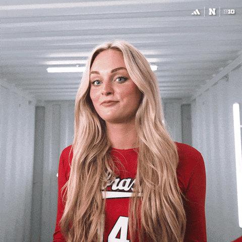 a woman in a red shirt with the number 4 on the front